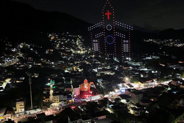 The figure of the San Jorge church is recreated with drones next to the church during the Saint George's Day celebrations at the Quintino neighborhood in Rio de Janeiro, Brazil on April 23, 2026. (Photo by Pablo PORCIUNCULA / AFP)