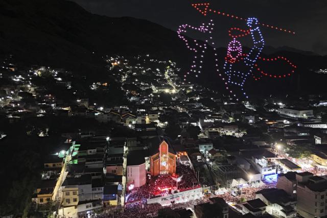 The figure of Saint George is recreated with drones next to the church during the Saint George's Day celebrations at the Quintino neighborhood in Rio de Janeiro, Brazil on April 23, 2026. (Photo by Pablo PORCIUNCULA / AFP)