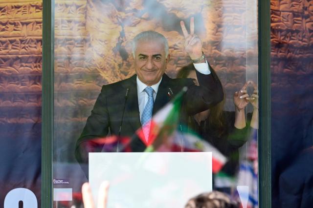 The son of Iran's last shah, exiled Crown Prince Reza Pahlavi flashes the victory sign as he addresses demonstrators in Berlin, on April 23, 2026. Pahlavi said during a press conference that any negotiation with the religious authorities in Tehran amounted to a "policy of appeasement," expressing hope that new protests would eventually overthrow the regime. (Photo by John MACDOUGALL / AFP)