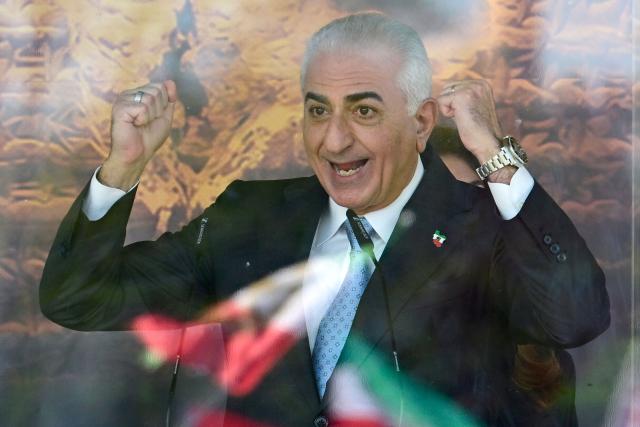 The son of Iran's last shah, exiled Crown Prince Reza Pahlavi gestures as he addresses demonstrators in Berlin, on April 23, 2026. Pahlavi said during a press conference that any negotiation with the religious authorities in Tehran amounted to a "policy of appeasement," expressing hope that new protests would eventually overthrow the regime. (Photo by John MACDOUGALL / AFP)
