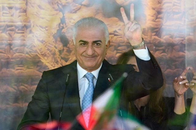 The son of Iran's last shah, exiled Crown Prince Reza Pahlavi flashes the victory sign as he addresses demonstrators in Berlin, on April 23, 2026. Pahlavi said during a press conference that any negotiation with the religious authorities in Tehran amounted to a "policy of appeasement," expressing hope that new protests would eventually overthrow the regime. (Photo by John MACDOUGALL / AFP)