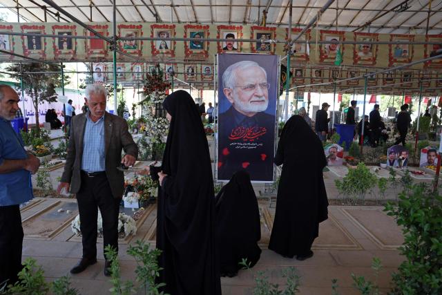 People pray over the grave of the former Iranian foreign minister Kamal Kharazi at the Behesht Zahra Cemetery in the south of Tehran on April 23, 2026. Kharazi who had been serving as the head of the Strategic Council for International Relations, which is part of the foreign ministry, died from wounds suffered in US-Israel strikes on April 1, Iranian media reported. (Photo by AFP) / 