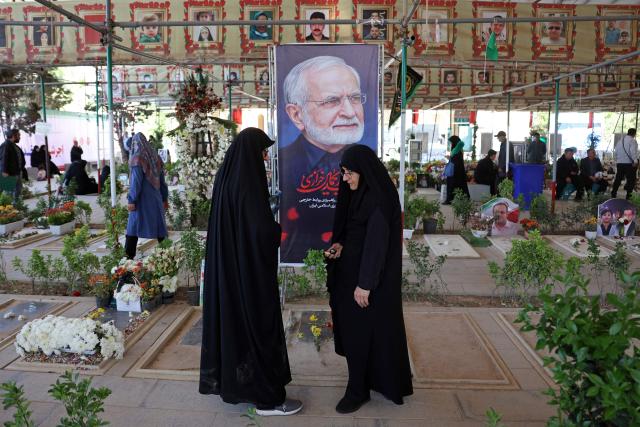 People pray over the grave of the former Iranian foreign minister Kamal Kharazi at the Behesht Zahra Cemetery in the south of Tehran on April 23, 2026. Kharazi who had been serving as the head of the Strategic Council for International Relations, which is part of the foreign ministry, died from wounds suffered in US-Israel strikes on April 1, Iranian media reported. (Photo by AFP) / 
