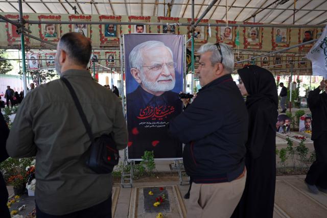 People pray over the grave of the former Iranian foreign minister Kamal Kharazi at the Behesht Zahra Cemetery in the south of Tehran on April 23, 2026. Kharazi who had been serving as the head of the Strategic Council for International Relations, which is part of the foreign ministry, died from wounds suffered in US-Israel strikes on April 1, Iranian media reported. (Photo by AFP) / 