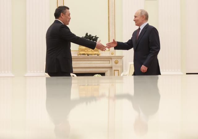 Russian President Vladimir Putin and Kyrgyzstan's President Sadyr Japarov shake hands during their meeting at the Kremlin in Moscow on April 23, 2026. (Photo by MAXIM SHIPENKOV / POOL / AFP)