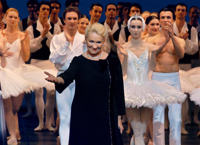 (FILES) Former prima ballerina Claude Bessy (C), who is set to step down as director of her dance school at the end of the season, waves to the audience on March 30, 2004 on the stage of the Palais Garnier in Paris, during an evening of tributes and testimonials to the significance of her work over the past thirty years. Former prima ballerina Claude Bessy, who headed the Paris Opera Ballet School for 30 years and revolutionised its teaching methods, died on April 23, 2026 at the age of 93, the institution announced. (Photo by STEPHANE DE SAKUTIN / AFP)
