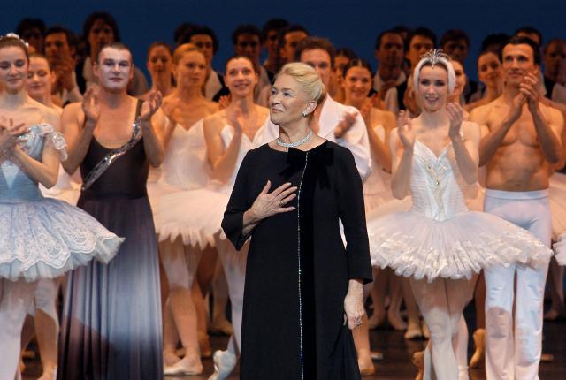 (FILES) Former prima ballerina Claude Bessy (C), who is set to step down as director of her dance school at the end of the season, waves to the audience on March 30, 2004 on the stage of the Palais Garnier in Paris, during an evening of tributes and testimonials to the significance of her work over the past thirty years. Former prima ballerina Claude Bessy, who headed the Paris Opera Ballet School for 30 years and revolutionised its teaching methods, died on April 23, 2026 at the age of 93, the institution announced. (Photo by STEPHANE DE SAKUTIN / AFP)