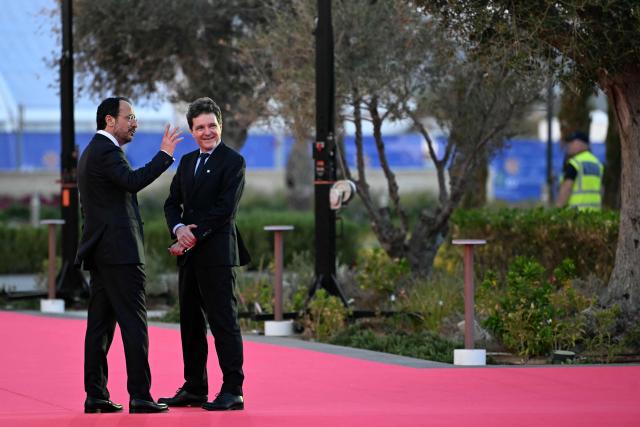 Cyprus' President Nikos Christodoulides (L) welcomes Romania's President Nicusor Dan upon the latter's arrival ahead of an informal meeting of the European Council, in Ayia Napa on April 23, 2026. (Photo by NICOLAS TUCAT / AFP)