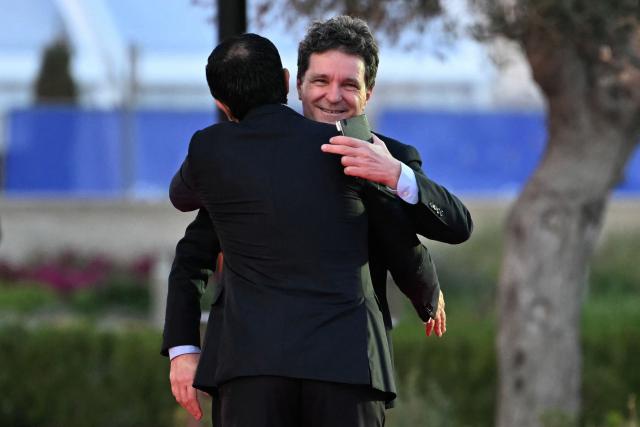 Cyprus' President Nikos Christodoulides (L) welcomes Romania's President Nicusor Dan upon the latter's arrival ahead of an informal meeting of the European Council, in Ayia Napa on April 23, 2026. (Photo by NICOLAS TUCAT / AFP)