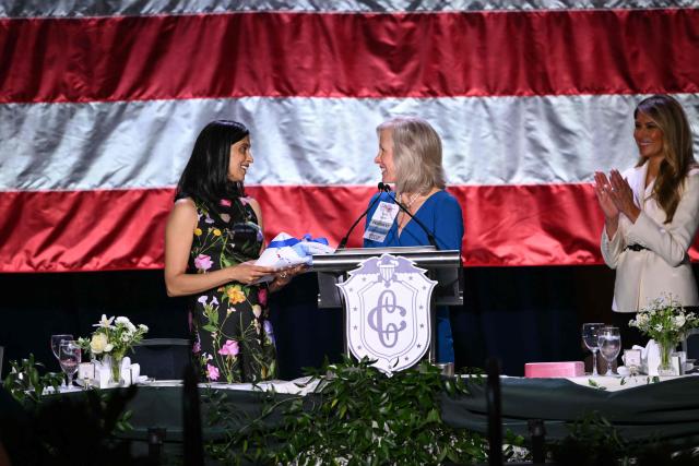 US First Lady Melania Trump (R) looks on as US Second Lady Usha Vance (L) receives a baby blanket as a gift during the 113th Annual First Lady’s Luncheon hosted by The Congressional Club Museum and Foundation at the Washington Hilton in Washington, DC on April 23, 2026.  (Photo by Mandel NGAN / AFP)