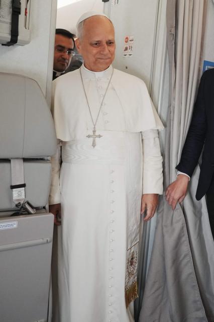 Pope Leo XIV meets with journalists aboard the papal flight from Malabo to Rome, on April 23, 2026, at the end of his 11-day pastoral visit to Africa. (Photo by Andrew Medichini / POOL / AFP)