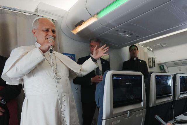 Pope Leo XIV speaks to journalists aboard the papal flight from Malabo to Rome, on April 23, 2026, at the end of his 11-day pastoral visit to Africa. (Photo by Andrew Medichini / POOL / AFP)