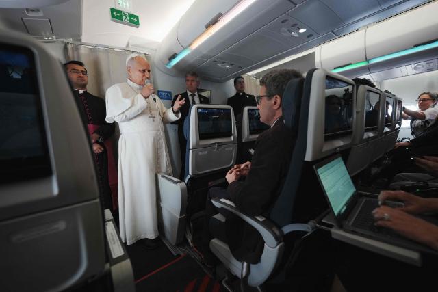 Pope Leo XIV speaks to journalists aboard the papal flight from Malabo to Rome, on April 23, 2026, at the end of his 11-day pastoral visit to Africa. (Photo by Andrew Medichini / POOL / AFP)