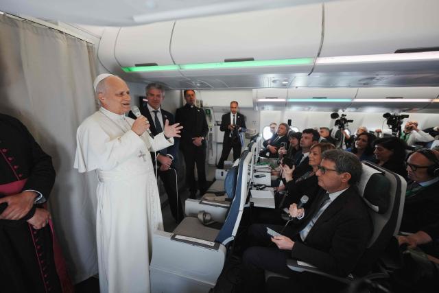 Pope Leo XIV speaks to journalists aboard the papal flight from Malabo to Rome, on April 23, 2026, at the end of his 11-day pastoral visit to Africa. (Photo by Andrew Medichini / POOL / AFP)