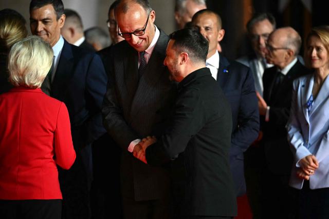 Germany's Chancellor Friedrich Merz (C) shakes hands with Ukraine's President Volodymyr Zelensky ahead of an informal meeting of the European Council, in Ayia Napa on April 23, 2026. (Photo by NICOLAS TUCAT / AFP)