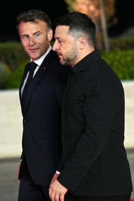 France's President Emmanuel Macron (L) and his Ukraine's counterpart Volodymyr Zelensky walk for a group photograph ahead of an informal meeting of the European Council, in Ayia Napa on April 23, 2026. (Photo by NICOLAS TUCAT / AFP)