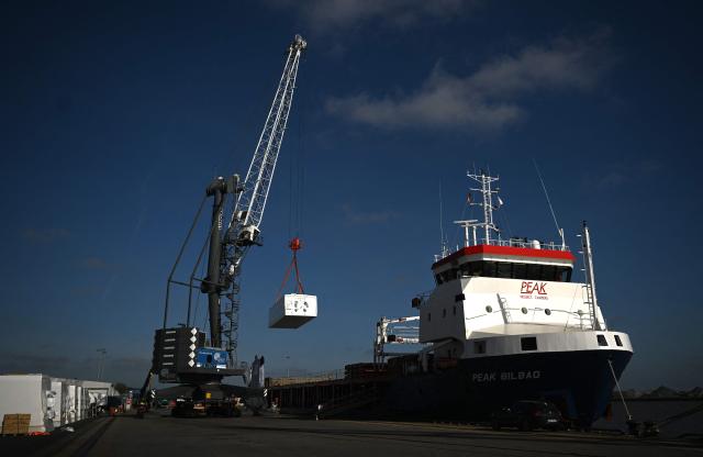 A crane moves a machine room for wind turbines to a transport vessel at the harbour in Emden, northwestern Germany, on April 23, 2026 during a media day ahead of the National Maritime Conference. The National Maritime Conference (NMK), scheduled for April 29 and 30, 2026, is the German government's central event for supporting the maritime industry. (Photo by Ina FASSBENDER / AFP)