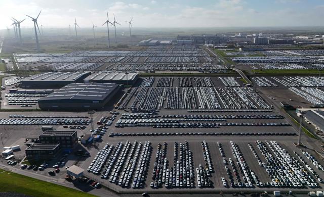 An aerial view shows new cars of the Volkswagen group ready for shipping close to the Volkswagen plant in Emden, northwestern Germany, on April 23, 2026 during a media day ahead of the National Maritime Conference. The National Maritime Conference (NMK), scheduled for April 29 and 30, 2026, is the German government's central event for supporting the maritime industry. (Photo by Ina FASSBENDER / AFP)