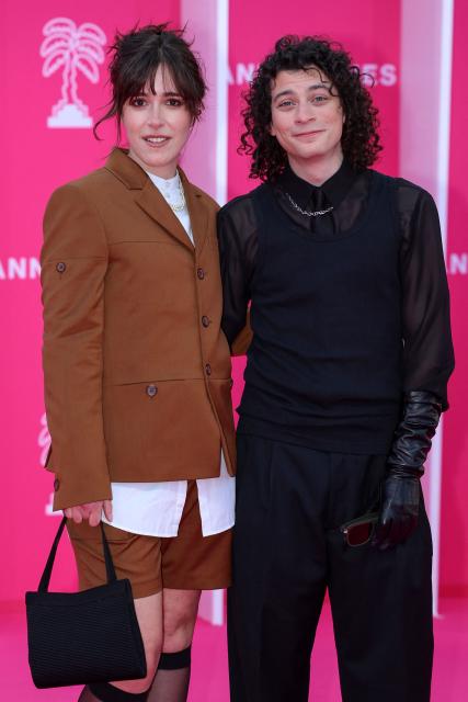 French actress Lou Howard and French comedian Roman Doduik pose on the pink carpet during the opening of the 9th edition of the Cannes International Series Festival (Canneseries) in Cannes, southern France, on April 23, 2026.  (Photo by Valery HACHE / AFP)