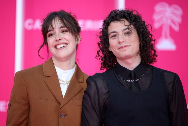 French actress Lou Howard and French comedian Roman Doduik pose on the pink carpet during the opening of the 9th edition of the Cannes International Series Festival (Canneseries) in Cannes, southern France, on April 23, 2026.  (Photo by Valery HACHE / AFP)