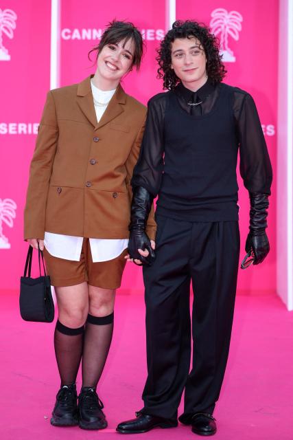 French actress Lou Howard and French comedian Roman Doduik pose on the pink carpet during the opening of the 9th edition of the Cannes International Series Festival (Canneseries) in Cannes, southern France, on April 23, 2026.  (Photo by Valery HACHE / AFP)