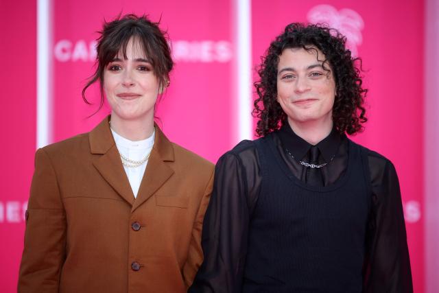 French actress Lou Howard and French comedian Roman Doduik pose on the pink carpet during the opening of the 9th edition of the Cannes International Series Festival (Canneseries) in Cannes, southern France, on April 23, 2026.  (Photo by Valery HACHE / AFP)