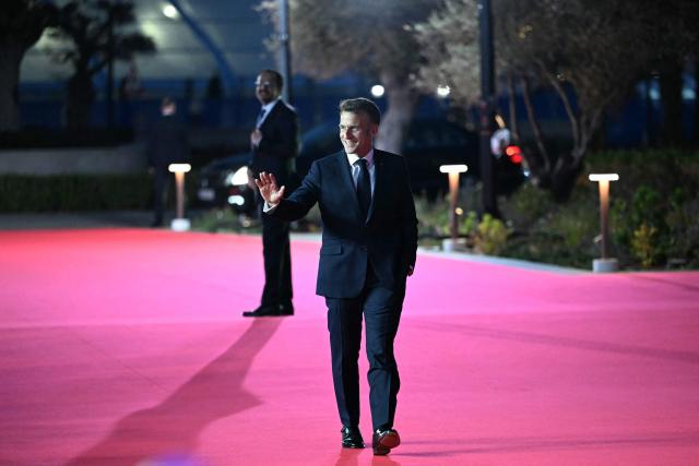France's President Emmanuel Macron walks past his Cypriot counterpart Nikos Christodoulides upon his arrival ahead of an informal meeting of the European Council, in Ayia Napa on April 23, 2026. (Photo by NICOLAS TUCAT / AFP)