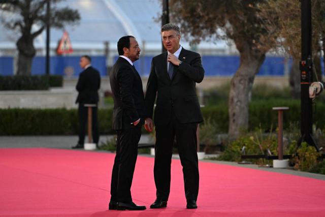 Cyprus' President Nikos Christodoulides (L) welcomes Croatia's Prime Minister Andrej Plenkovic upon the latter's arrival ahead of an informal meeting of the European Council, in Ayia Napa on April 23, 2026. (Photo by NICOLAS TUCAT / AFP)