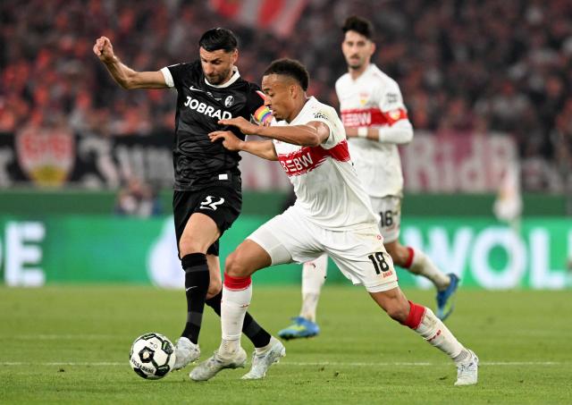 Stuttgart's German forward #18 Jamie Leweling (R) and Freiburg's Italian midfielder #32 Vincenzo Grifo vie for the ball during the German Cup (DFB-Pokal) semi-final football match between VfB Stuttgart and FC Freiburg in Stuttgart, southwestern Germany, on April 23, 2026. (Photo by THOMAS KIENZLE / AFP) / DFB REGULATIONS PROHIBIT ANY USE OF PHOTOGRAPHS AS IMAGE SEQUENCES AND QUASI-VIDEO.