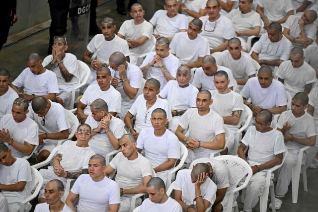 Alleged members of the Mara Salvatrucha (MS-13) gang attend a remote court hearing by videoconference at the Terrorism Confinement Center (CECOT) in Tecoluca, El Salvador on April 23, 2026. Nearly 490 alleged members of the powerful Central American gang Mara Salvatrucha (MS-13), including several alleged leaders, went on trial collectively in El Salvador, accused of thousands of murders. (Photo by MARVIN RECINOS / AFP)