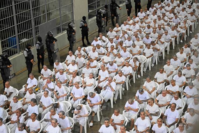 Alleged members of the Mara Salvatrucha (MS-13) gang attend a remote court hearing by videoconference at the Terrorism Confinement Center (CECOT) in Tecoluca, El Salvador on April 23, 2026. Nearly 490 alleged members of the powerful Central American gang Mara Salvatrucha (MS-13), including several alleged leaders, went on trial collectively in El Salvador, accused of thousands of murders. (Photo by MARVIN RECINOS / AFP)