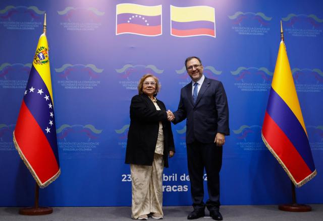 Venezuela's Foreign Minister Yvan Gil (R) shakes hands with his Colombian counterpart, Foreign Minister Rosa Yolanda Villavicencio, during a meeting in Caracas on April 23, 2026. (Photo by AFP)
