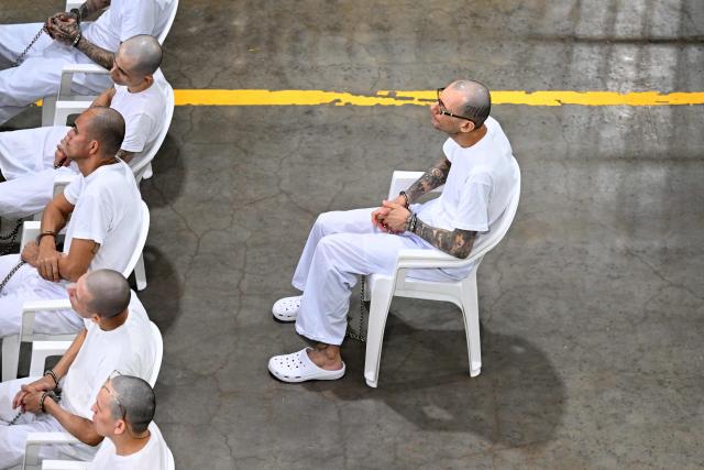 Dionisio Aristides Umanzor (R), also known as "Sirra," leader of the Mara Salvatrucha (MS-13) gang, attends a remote court hearing by videoconference at the Terrorism Confinement Center (CECOT) in Tecoluca, El Salvador on April 23, 2026. (Photo by Marvin RECINOS / AFP)