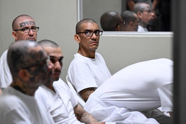 Borromeo Henriquez (R), also known as "El Diablito de Hollywood," leader of the Mara Salvatrucha (MS-13) gang, attends a remote court hearing by videoconference at the Terrorism Confinement Center (CECOT) in Tecoluca, El Salvador on April 23, 2026. (Photo by Marvin RECINOS / AFP)