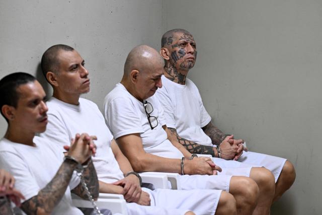 Carlos Tiberio Ramirez (R), also known as "Snaider de Pasadena," leader of the Mara Salvatrucha (MS-13) gang, attends a remote court hearing by videoconference at the Terrorism Confinement Center (CECOT) in Tecoluca, El Salvador on April 23, 2026. (Photo by Marvin RECINOS / AFP)