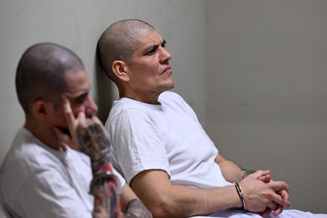 Cesar Antonio Lopez (R), also known as "Grenas de Stoner," leader of the Mara Salvatrucha (MS-13) gang, attends a remote court hearing by videoconference at the Terrorism Confinement Center (CECOT) in Tecoluca, El Salvador on April 23, 2026. (Photo by Marvin RECINOS / AFP)