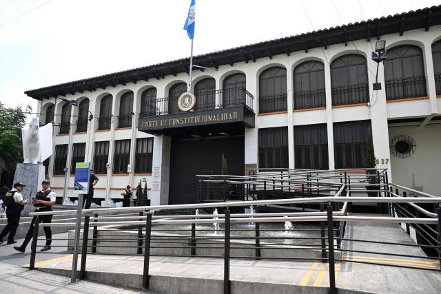 Guatemalan police officers stand guard at the Constitutional Court in Guatemala City on April 23, 2026. (Photo by Johan ORDONEZ / AFP)
