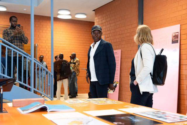 Architect Francis Kere (C), gives a tour of the building to guests at the Goethe-Institut German cultural centre in Dakar on April 16, 2026. The bricks are local, the open-air ventilation is abundant, and a single towering baobab unites it all: architect Francis Kere's new building in Dakar is simultaneously sustainable and distinctly African.
A dual national of Burkina Faso and Germany, Kere is the only African to have won the Pritzker Prize (2022), architecture's most prestigious award. (Photo by SEYLLOU / AFP)