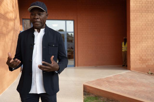 Architect Francis Kere speaks to members of the media at the Goethe-Institut German cultural centre in Dakar on April 16, 2026. The bricks are local, the open-air ventilation is abundant, and a single towering baobab unites it all: architect Francis Kere's new building in Dakar is simultaneously sustainable and distinctly African.
A dual national of Burkina Faso and Germany, Kere is the only African to have won the Pritzker Prize (2022), architecture's most prestigious award. (Photo by SEYLLOU / AFP)