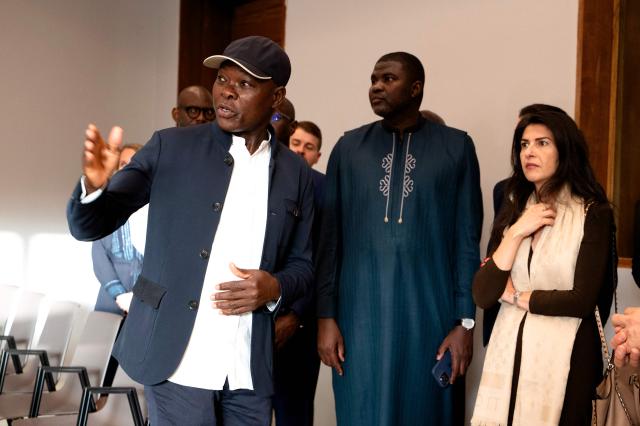 Architect Francis Kere (L) speaks to German politician Serap Guler (R), in the presence of Senagal's Minister of Culture Amadou Ba at the Goethe-Institut German cultural centre in Dakar on April 16, 2026. The bricks are local, the open-air ventilation is abundant, and a single towering baobab unites it all: architect Francis Kere's new building in Dakar is simultaneously sustainable and distinctly African.
A dual national of Burkina Faso and Germany, Kere is the only African to have won the Pritzker Prize (2022), architecture's most prestigious award. (Photo by SEYLLOU / AFP)