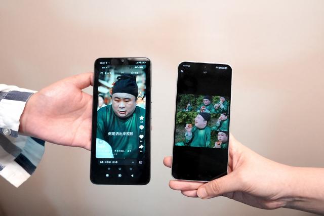 This photo illustration taken in Hong Kong on April 16, 2026 shows phones displaying the screenshots of Chinese Hanfu stylist Baicai's social media post (L) and the AI microdrama (R) accused of stealing his likeness without authorization. Two people told AFP their likenesses were cast without consent in the AI-generated show "The Peach Blossom Hairpin", which ran on Hongguo, a major microdrama app owned by Tiktok parent company ByteDance.
Microdramas are ultra-short, online soap operas hugely popular in China and elsewhere.
Hongguo hosts thousands of free, bite-sized shows -- both live-action and AI-generated -- whose episodes are two or three minutes long. (Photo by Mahmoud RIZK / AFP) / To go with 'China-AI-Entertainment-Legal' focus by Sophia Xu and Purple Romero
