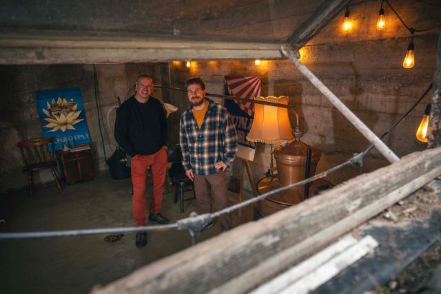 Ivan Lakatos (R) and Miroslav Basic (R) pose in their gin distillery in the village of Belegis near Stara Pazova, on March 28, 2026. In Serbia, as across much of the gin industry, juniper is not farmed but instead gathered from wild bushes by hand. Juniper has declined in parts of Europe over the past few decades particularly in lowland areas where it once grew. Studies show the species is struggling to regenerate in many areas, with climate change, grazing and habitat loss all contributing to declining populations. (Photo by Andrej ISAKOVIC / AFP)