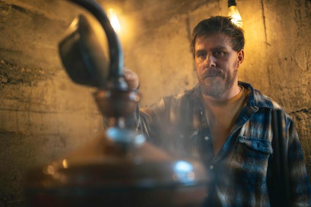 Ivan Lakatos works on the distillation process in his gin distillery in the village of Belegis near Stara Pazova, on March 28, 2026. In Serbia, as across much of the gin industry, juniper is not farmed but instead gathered from wild bushes by hand. Juniper has declined in parts of Europe over the past few decades particularly in lowland areas where it once grew. Studies show the species is struggling to regenerate in many areas, with climate change, grazing and habitat loss all contributing to declining populations. (Photo by Andrej ISAKOVIC / AFP)