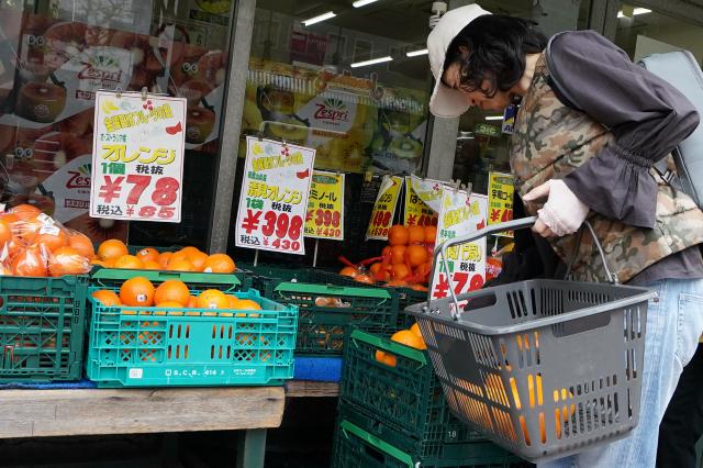 A customer looks for fruit at a supermarket in Tokyo on April 24, 2026. Japan's core inflation accelerated to 1.8 percent in March, government data showed April 24, largely driven by rising food prices. (Photo by Kazuhiro NOGI / AFP)