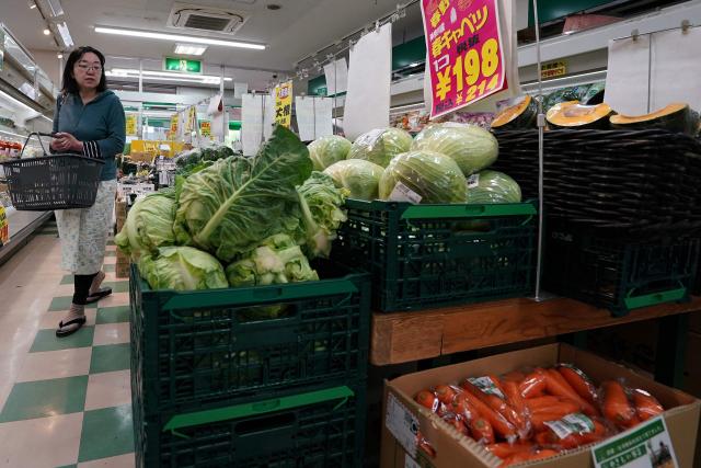 A customer looks for vegetables at a supermarket in Tokyo on April 24, 2026. Japan's core inflation accelerated to 1.8 percent in March, government data showed April 24, largely driven by rising food prices. (Photo by Kazuhiro NOGI / AFP)