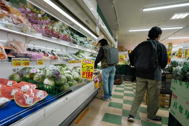 Customers look for vegetables at a supermarket in Tokyo on April 24, 2026. Japan's core inflation accelerated to 1.8 percent in March, government data showed April 24, largely driven by rising food prices. (Photo by Kazuhiro NOGI / AFP)