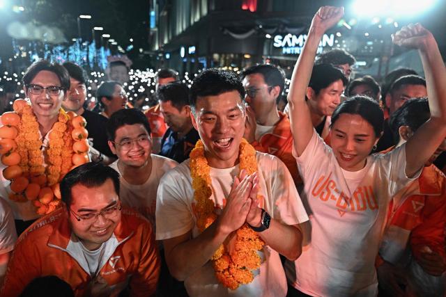 (FILES) People's Party leader and prime ministerial candidate Natthaphong Ruengpanyawut (C) along with fellow party members attends a campaign rally ahead of the general election in Bangkok on January 25, 2026. A Thai court on April 24 decided to hear a case against 10 MPs including the leader of the largest opposition party for trying to reform the royal insult law, but refrained from suspending them. (Photo by Lillian SUWANRUMPHA / AFP)