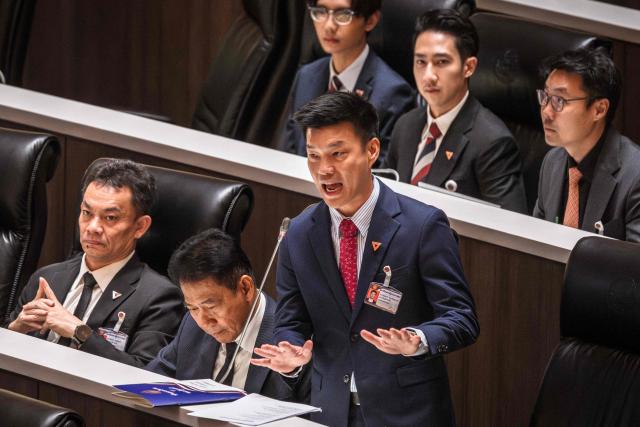 (FILES) People's Party (PP) leader Natthaphong Ruengpanyawut (C) speaks at the parliament chamber in Bangkok on April 9, 2026. A Thai court on April 24 decided to hear a case against 10 MPs including the leader of the largest opposition party for trying to reform the royal insult law, but refrained from suspending them. (Photo by chanakarn LAOSARAKHAM / AFP)
