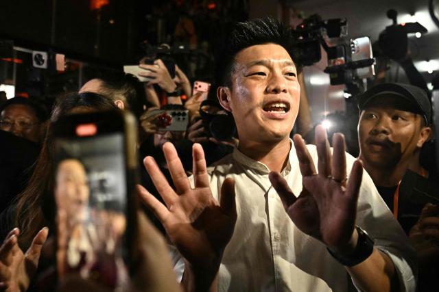 (FILES) People's Party leader and prime ministerial candidate Natthaphong Ruengpanyawut gestures at his party's headquarters after conceding defeat in Thailand's general election in Bangkok on February 8, 2026. A Thai court on April 24 decided to hear a case against 10 MPs including the leader of the largest opposition party for trying to reform the royal insult law, but refrained from suspending them. (Photo by Lillian SUWANRUMPHA / AFP)