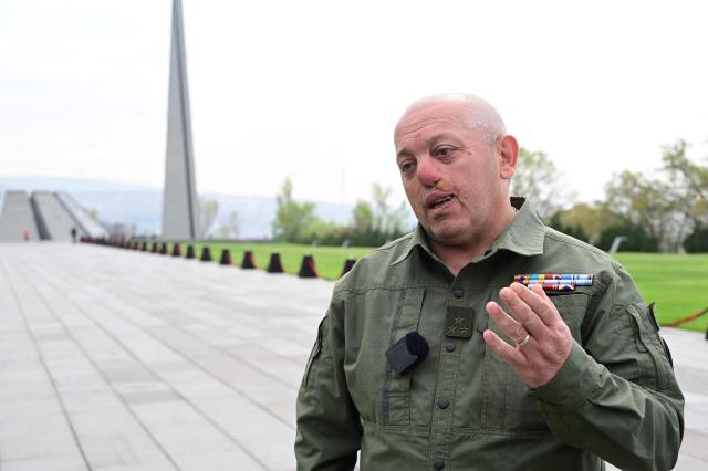 Artur Avanesyan, an army veteran and member of the 'Strong Armenia' party led by billionaire opposition figure Samvel Karapetyan, talks to AFP reporters at the Tsitsernakaberd Armenian Genocide Memorial in Yerevan on April 23, 2026, on the eve of the Genocide Remembrance Day - which will mark the 111th anniversary of the World War I-era mass killings of Armenians under the Ottoman Empire in 1915. (Photo by KAREN MINASYAN / AFP)